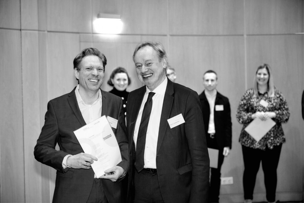 Ein Mitarbeitender der innovas mit dem Präsidenten Prof. Dr. Hartmut Ihne bei der Übergabe der Förderurkunde der Hochschule Bonn-Rhein-Sieg an die innovas GmbH
